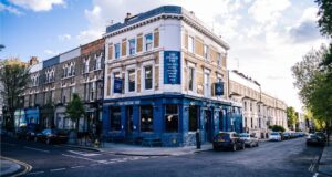 Corner pub with blue painted ground floor and cream Victorian upper storeys, Notting Hill
