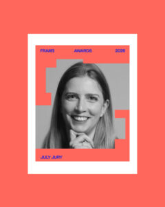 Poster for FRAME Awards 2026 featuring a grayscale portrait of a smiling woman framed by coral geometric shapes; top text reads FRAME AWARDS 2026, bottom left reads JULY JURY, on a coral background.